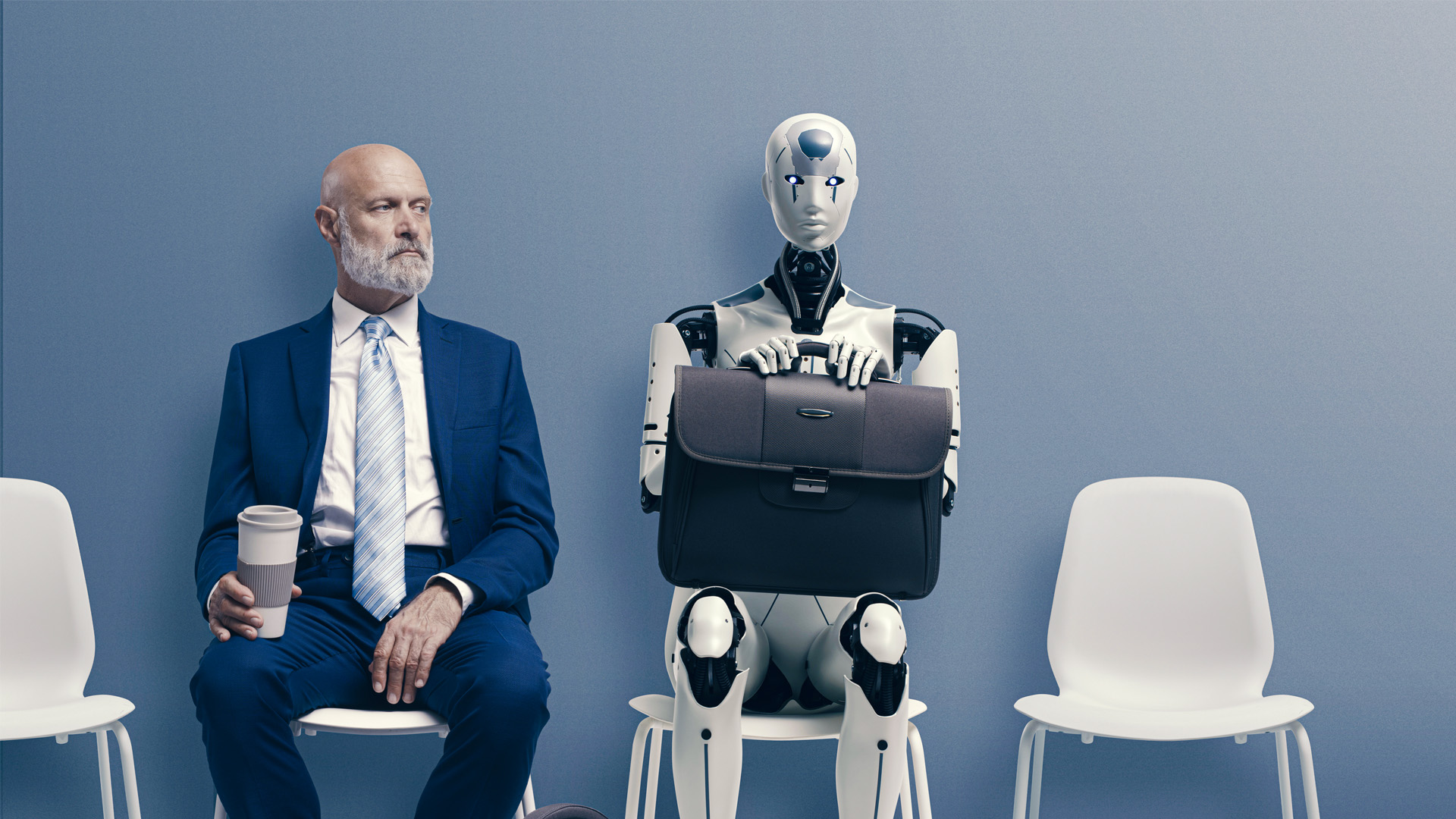 Man in suit waiting for interview next to AI humanoid
